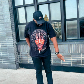 Person wearing a black t-shirt with a Rick James graphic design